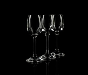 Photo of Set of empty glasses on black background