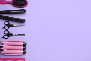 Photo of Flat lay composition of professional hairdresser tools on lilac background, space for text