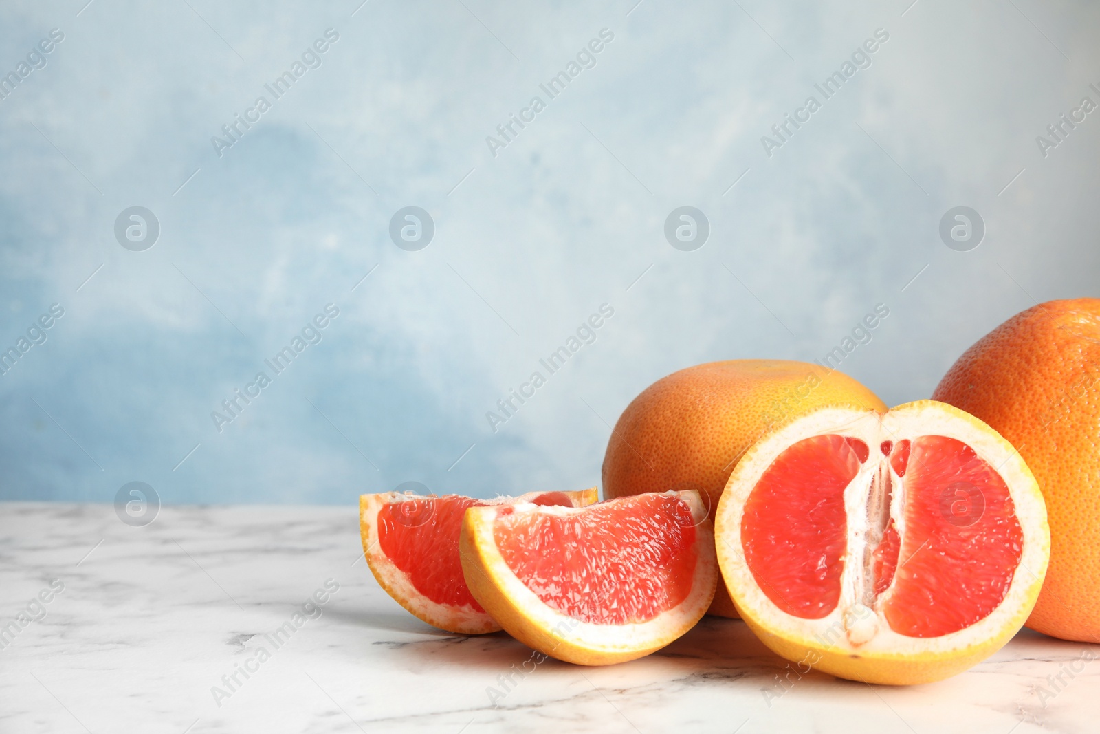 Photo of Fresh tasty grapefruits on table. Space for text