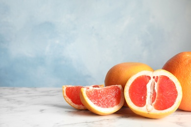 Photo of Fresh tasty grapefruits on table. Space for text