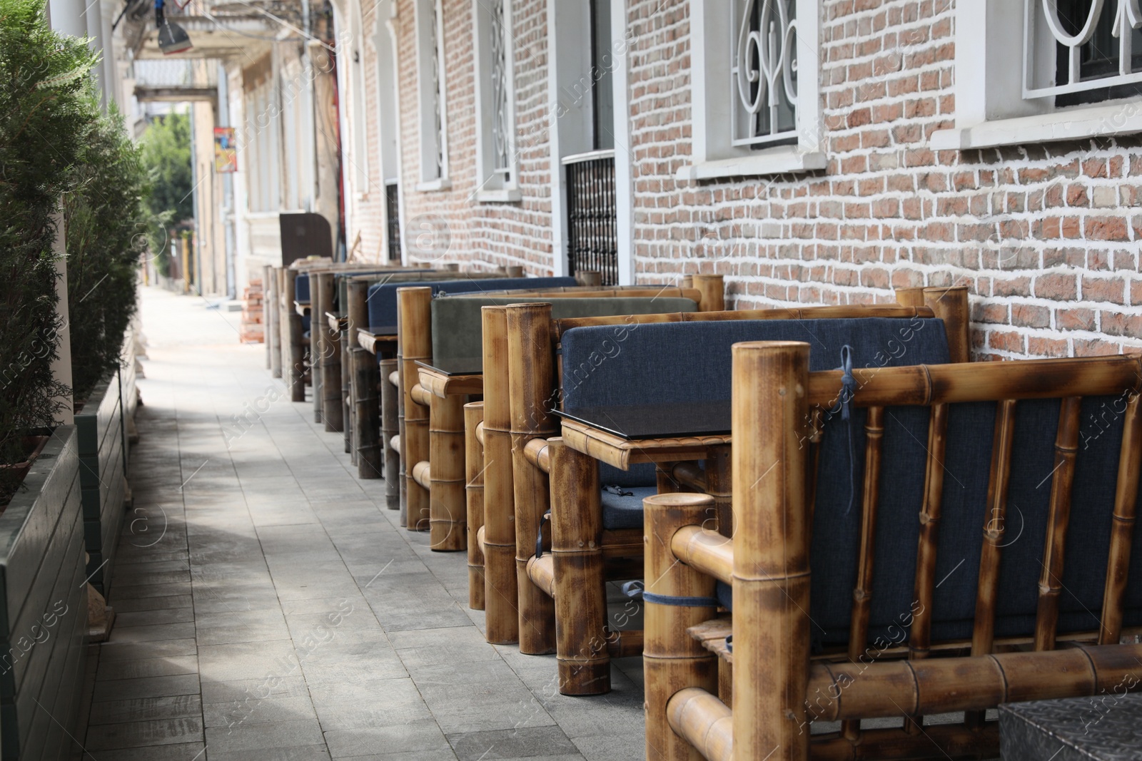 Photo of Kutaisi, Georgia - September 2, 2022: Beautiful wooden furniture near building outdoors