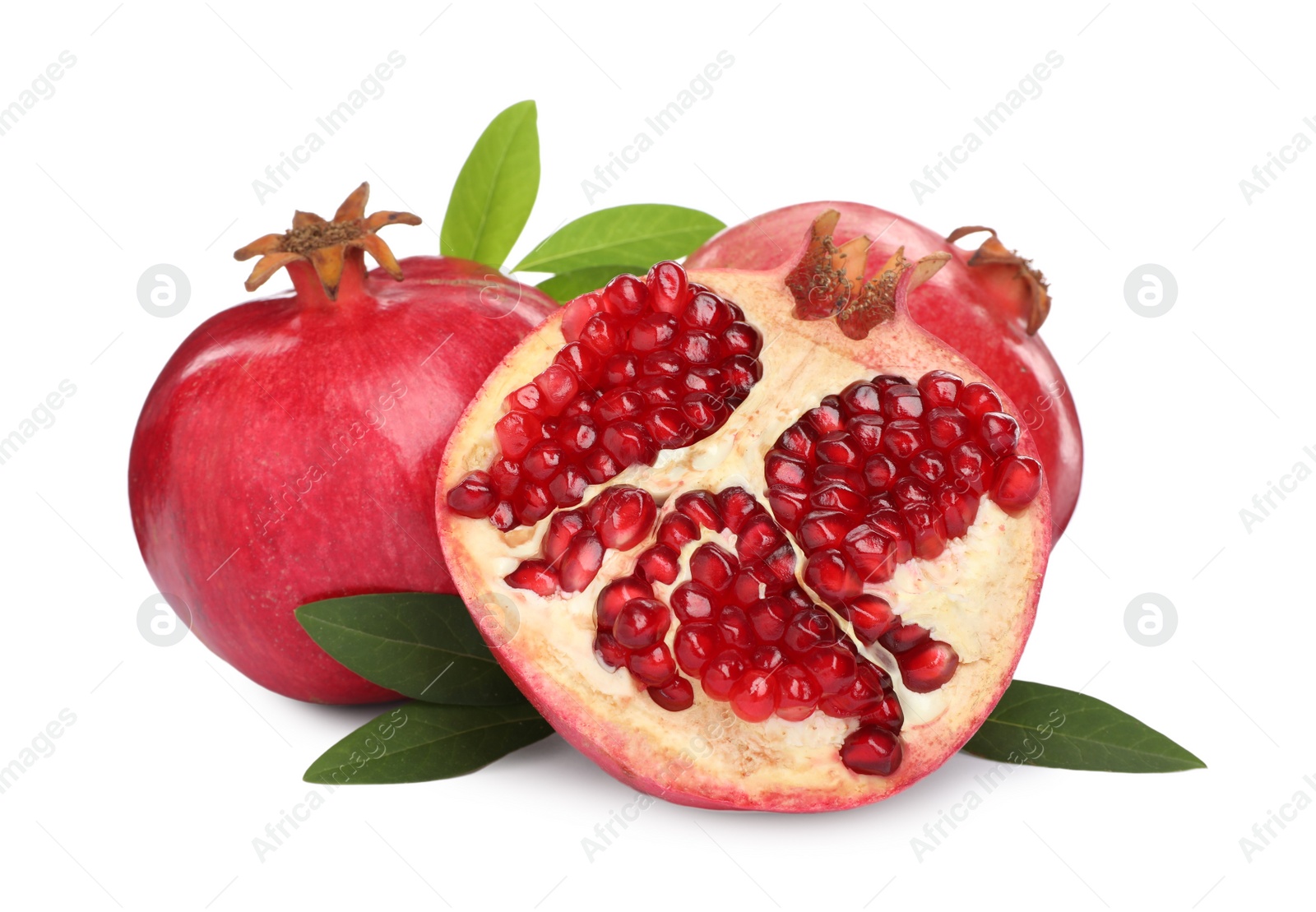 Photo of Ripe pomegranates with green leaves on white background