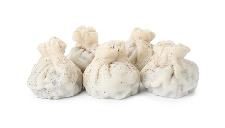 Photo of Tasty fresh khinkali (dumplings) and spices isolated on white. Georgian cuisine