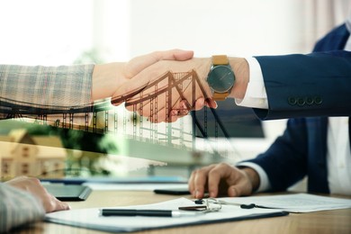 Support or partnership concept. Double exposure with bridge and photo of businesspeople shaking hands over table in office