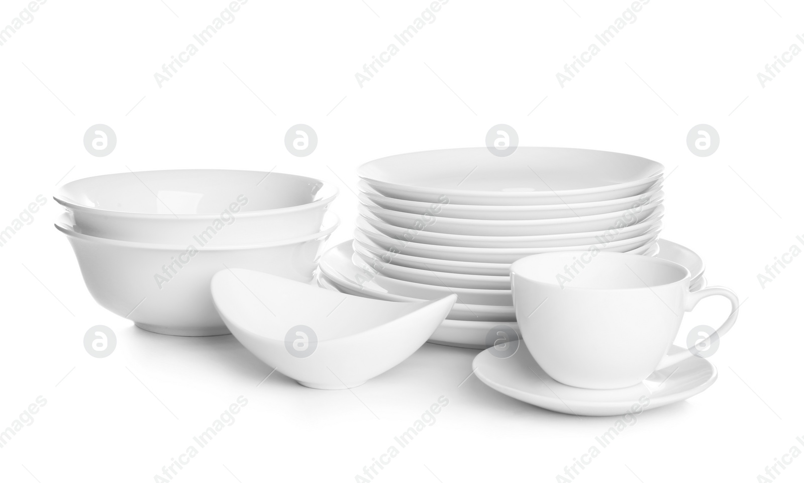 Photo of Stacks of ceramic dishware on white background