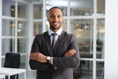 Photo of Happy man with crossed arms in office. Lawyer, businessman, accountant or manager