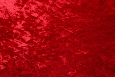 Photo of Texture of red velvet fabric as background, top view