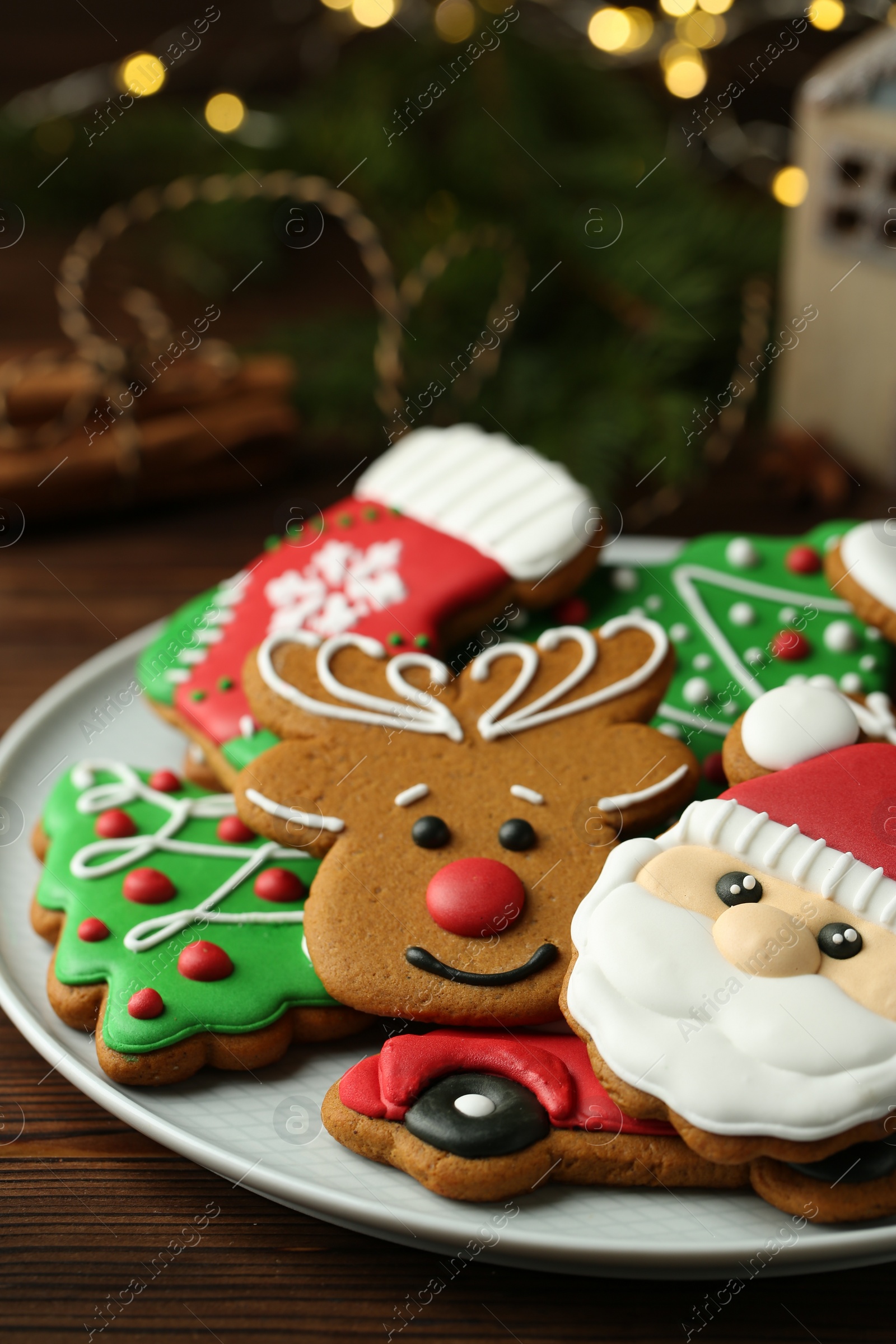 Photo of Different tasty Christmas cookies on wooden table, closeup. Space for text