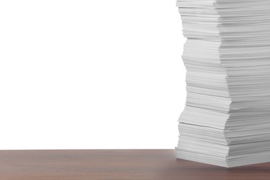 Photo of Stack of paper sheets on wooden table against white background. Space for text