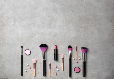 Photo of Flat lay composition with professional makeup products on grey background