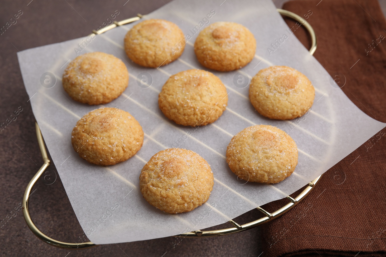 Photo of Tasty sweet sugar cookies on brown table, closeup