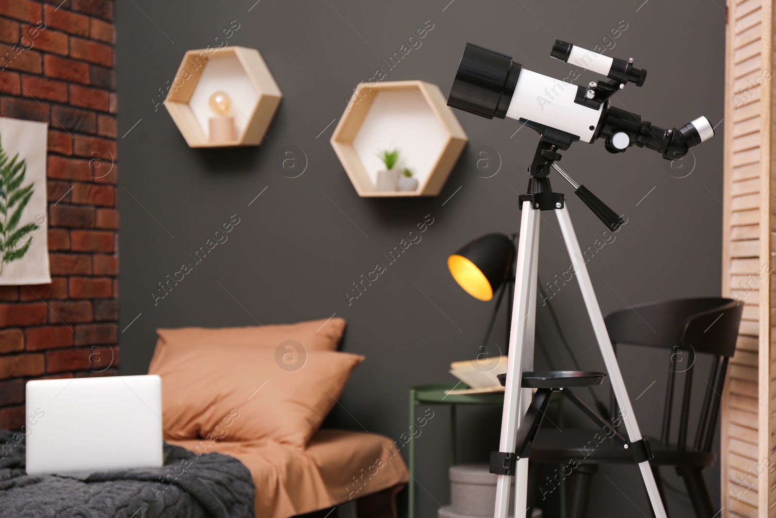 Photo of Tripod with modern telescope in stylish room. Space for text