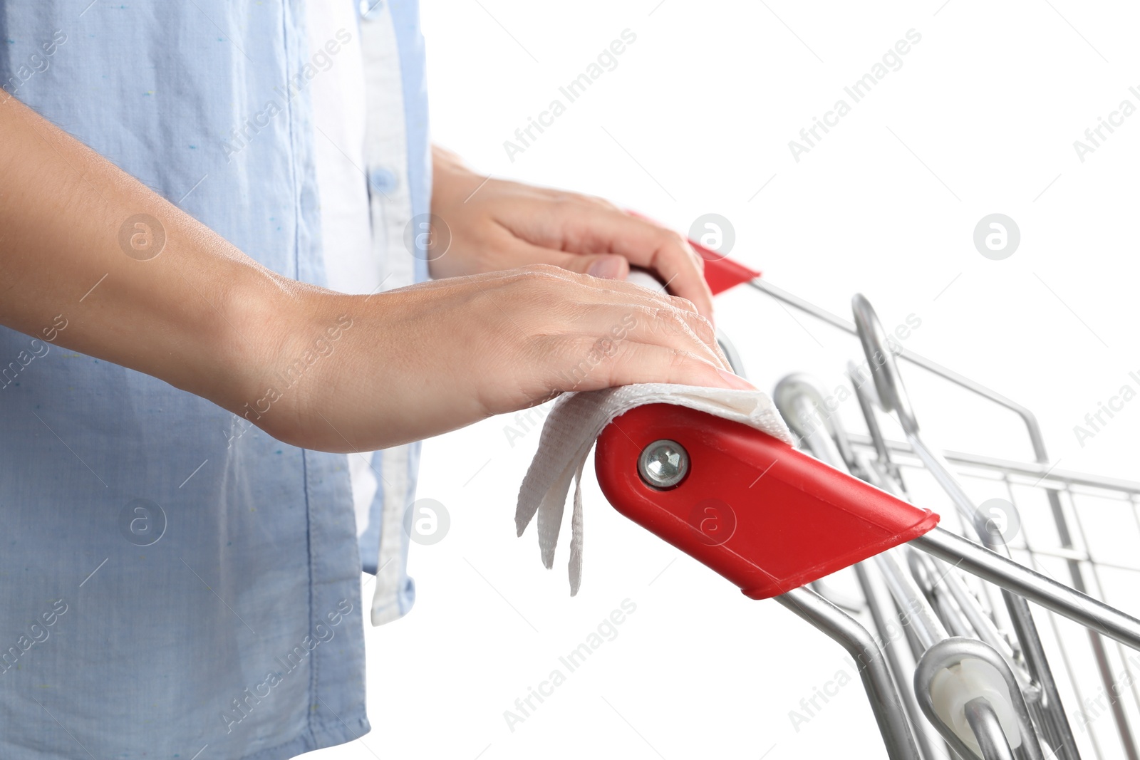 Photo of Woman holding shopping cart handle with tissue paper on white background, closeup