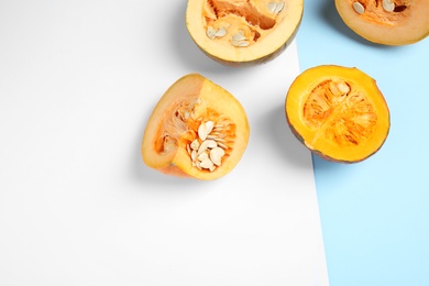 Photo of Fresh ripe pumpkins on color background, flat lay with space for text. Holiday decoration