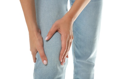 Woman having knee problems on white background, closeup