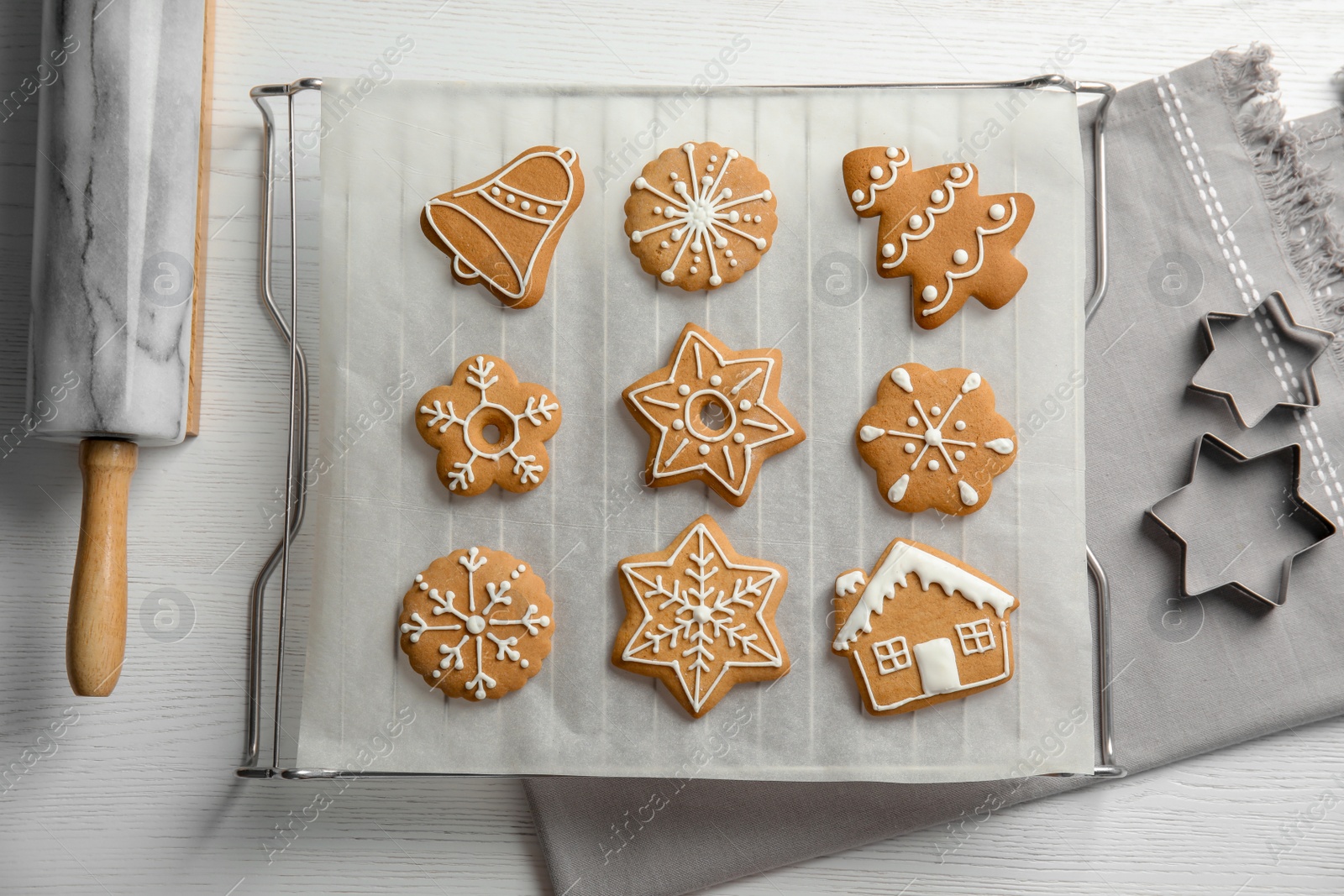 Photo of Tasty decorated Christmas cookies on baking table, top view