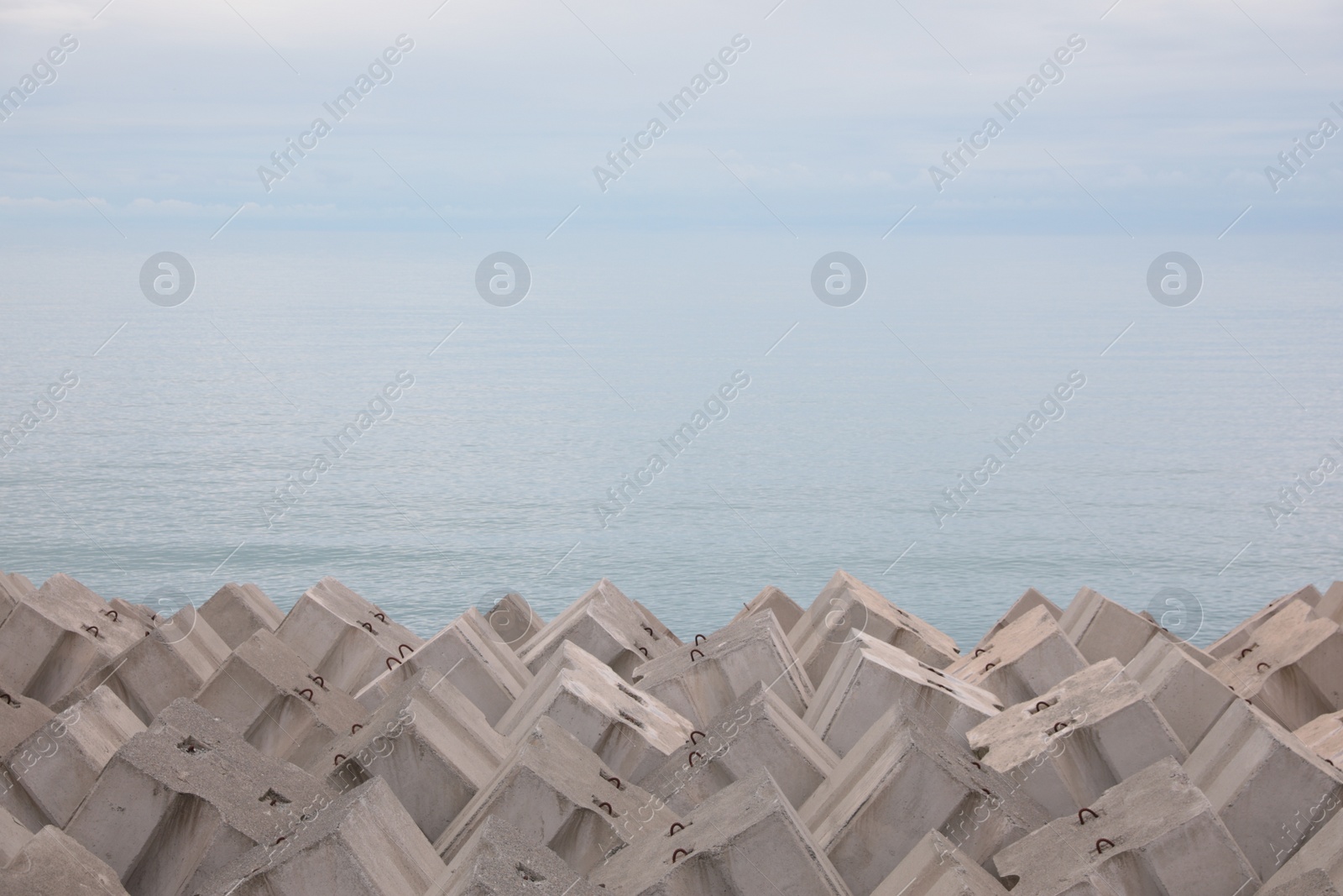 Photo of Picturesque view of many concrete slabs near sea. Space for text