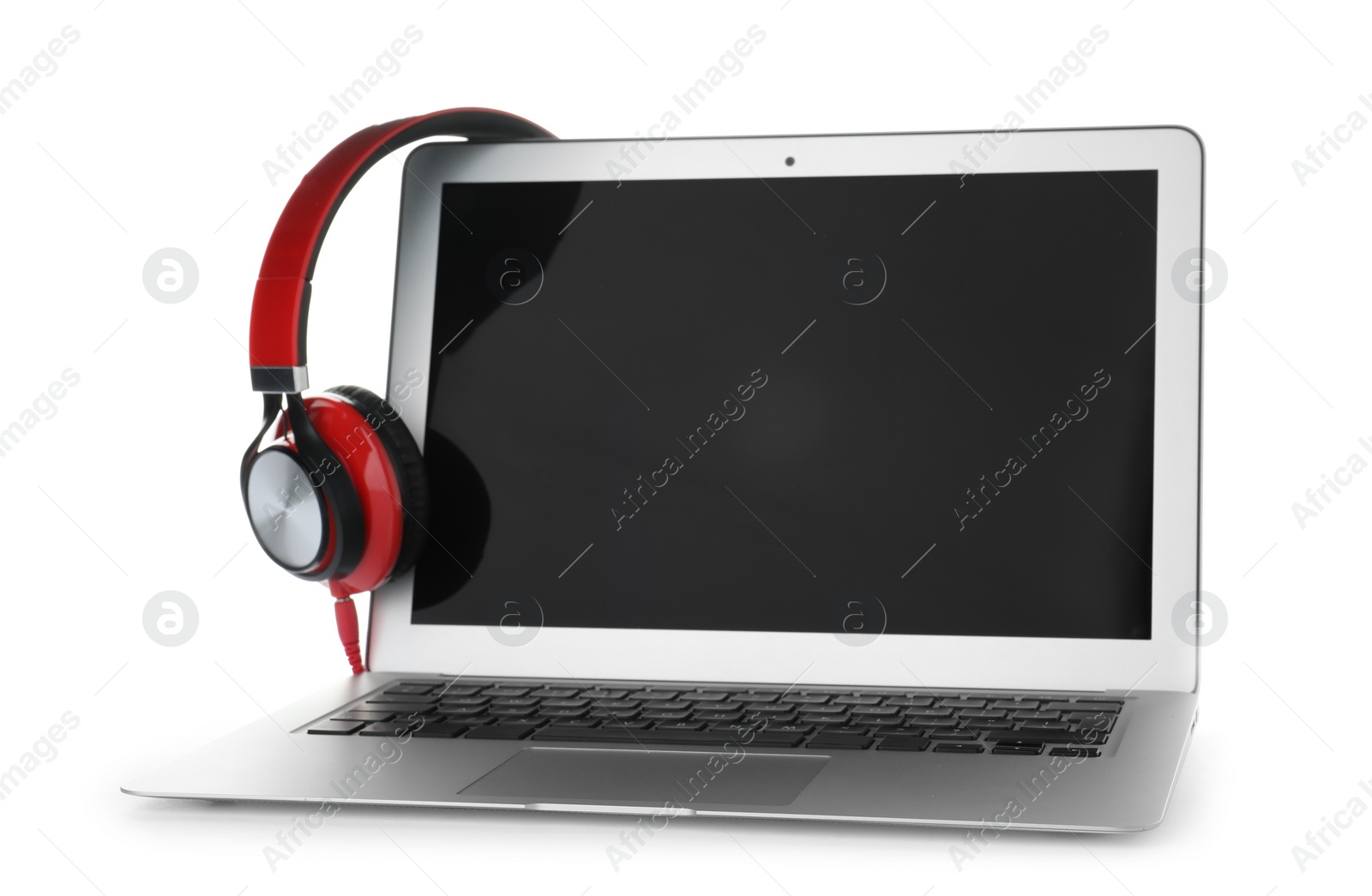 Photo of Laptop with blank screen and headphones on white background