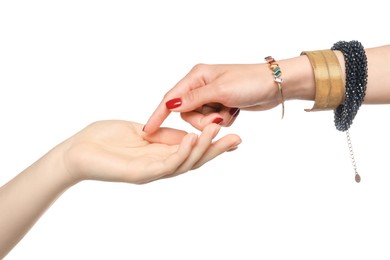 Photo of Fortune teller reading lines on woman's palm against white background. Chiromancy