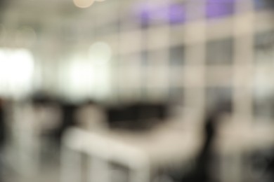 Photo of Blurred view of cozy workspaces with tables and chairs in office