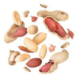 Peanuts and crushed pods in air on white background