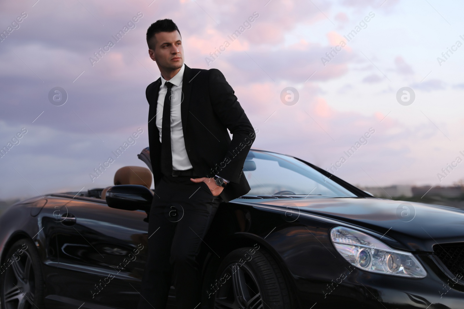 Photo of Handsome businessman near luxury convertible car outdoors
