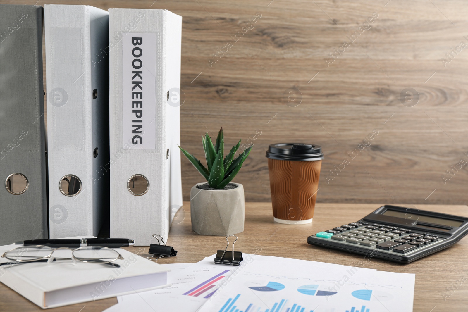 Photo of Bookkeeper's workplace with folders and documents on table