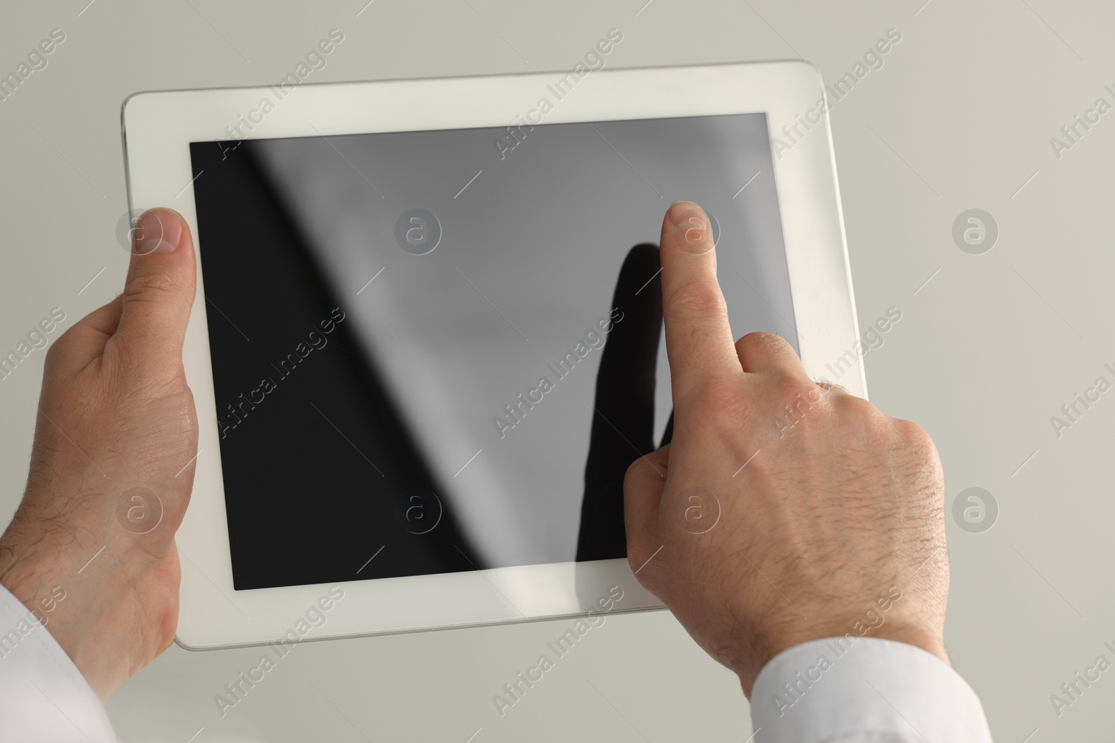 Photo of Closeup view of man using new tablet indoors