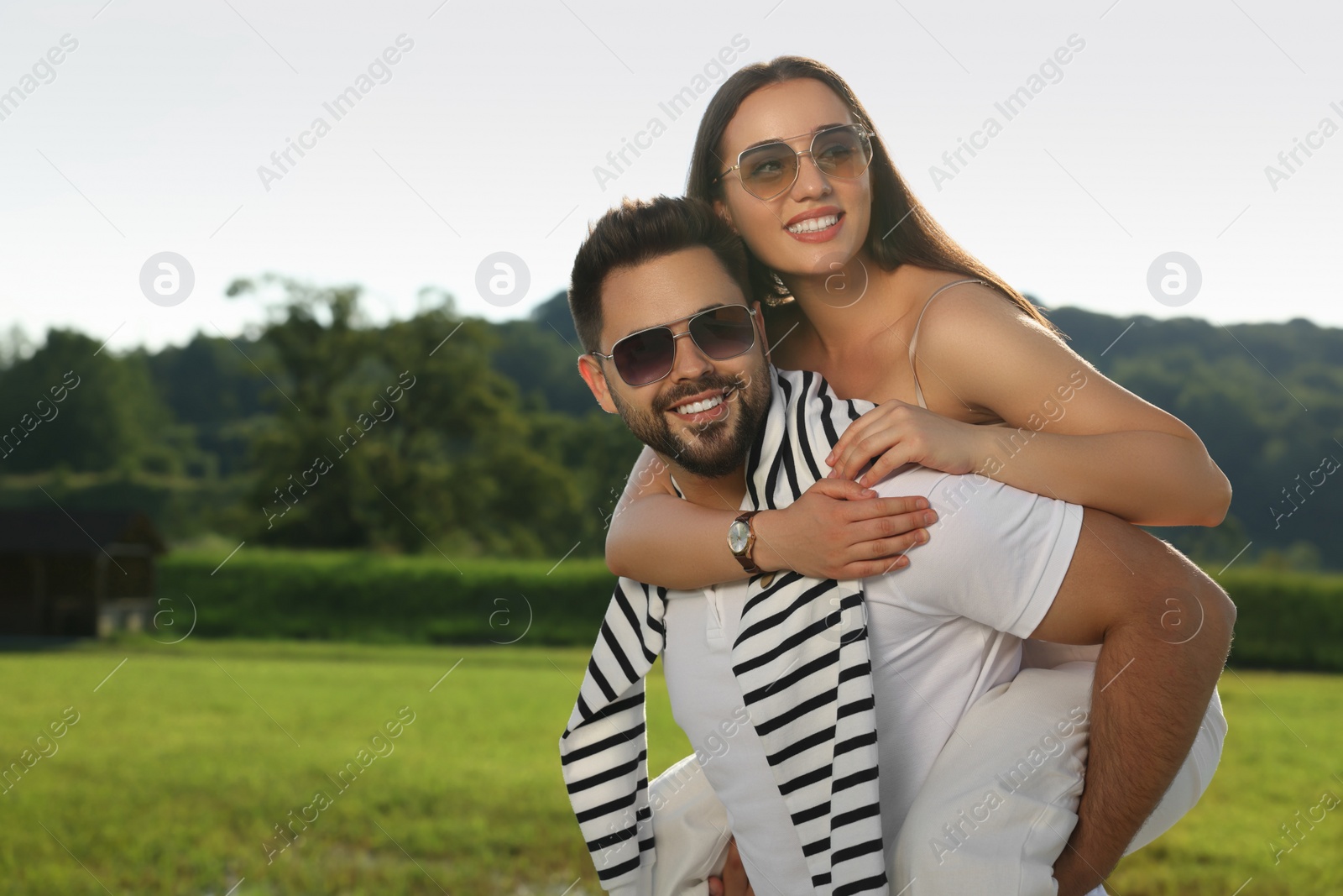 Photo of Romantic date. Beautiful couple spending time together in park, space for text