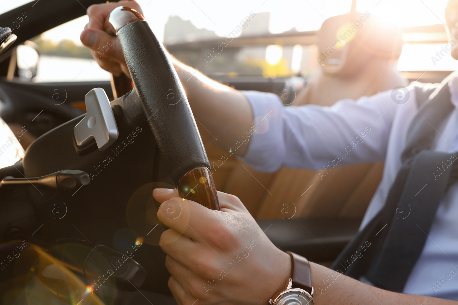 Photo of Stylish man driving luxury convertible car, closeup