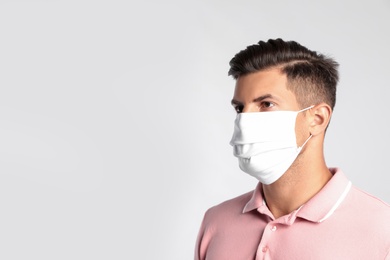 Photo of Man in protective face mask on white background
