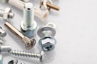 Photo of Many different fasteners on plastic surface, closeup. Space for text