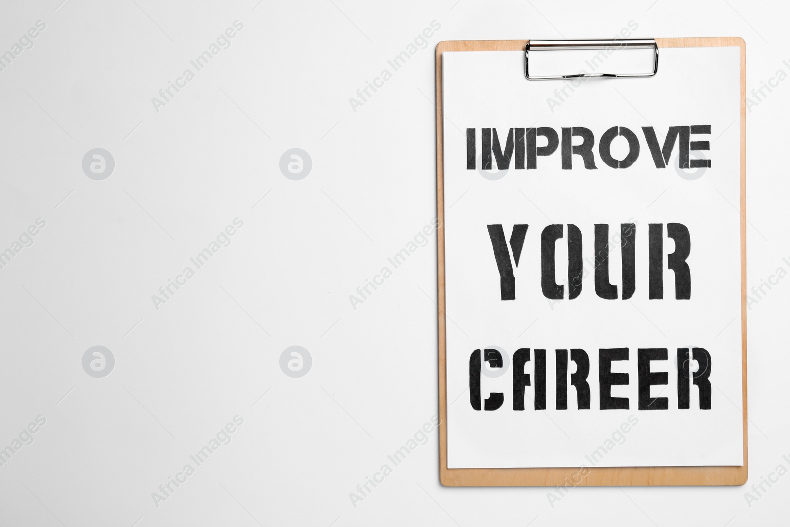 Photo of Clipboard with words IMPROVE YOUR CAREER on white background, top view. Space for text