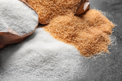 Paper bags with different types of sugar on table