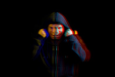 Image of Paranoia. Man screaming on black background, glitch effect