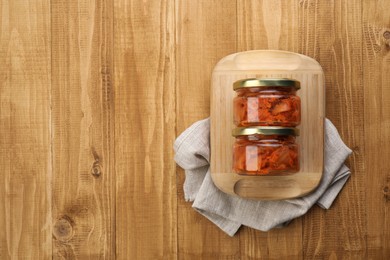 Photo of Delicious kimchi with Chinese cabbage on wooden table, flat lay. Space for text