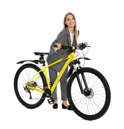 Young businesswoman with bicycle on white background