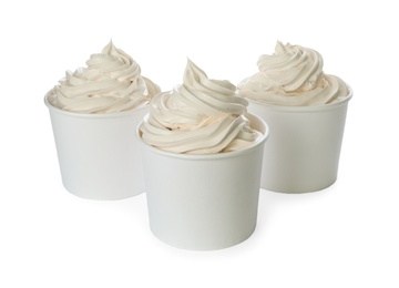 Photo of Cups with tasty frozen yogurt on white background