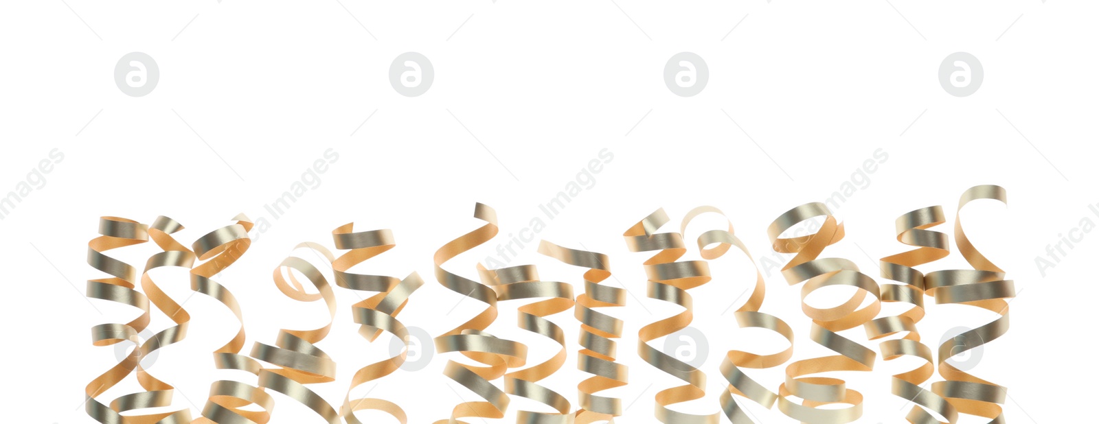 Photo of Shiny serpentine streamers on white background. Festive decor