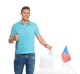 Photo of Man putting ballot paper into box against white background