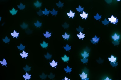 Photo of Beautiful maple leaf shaped lights on dark background