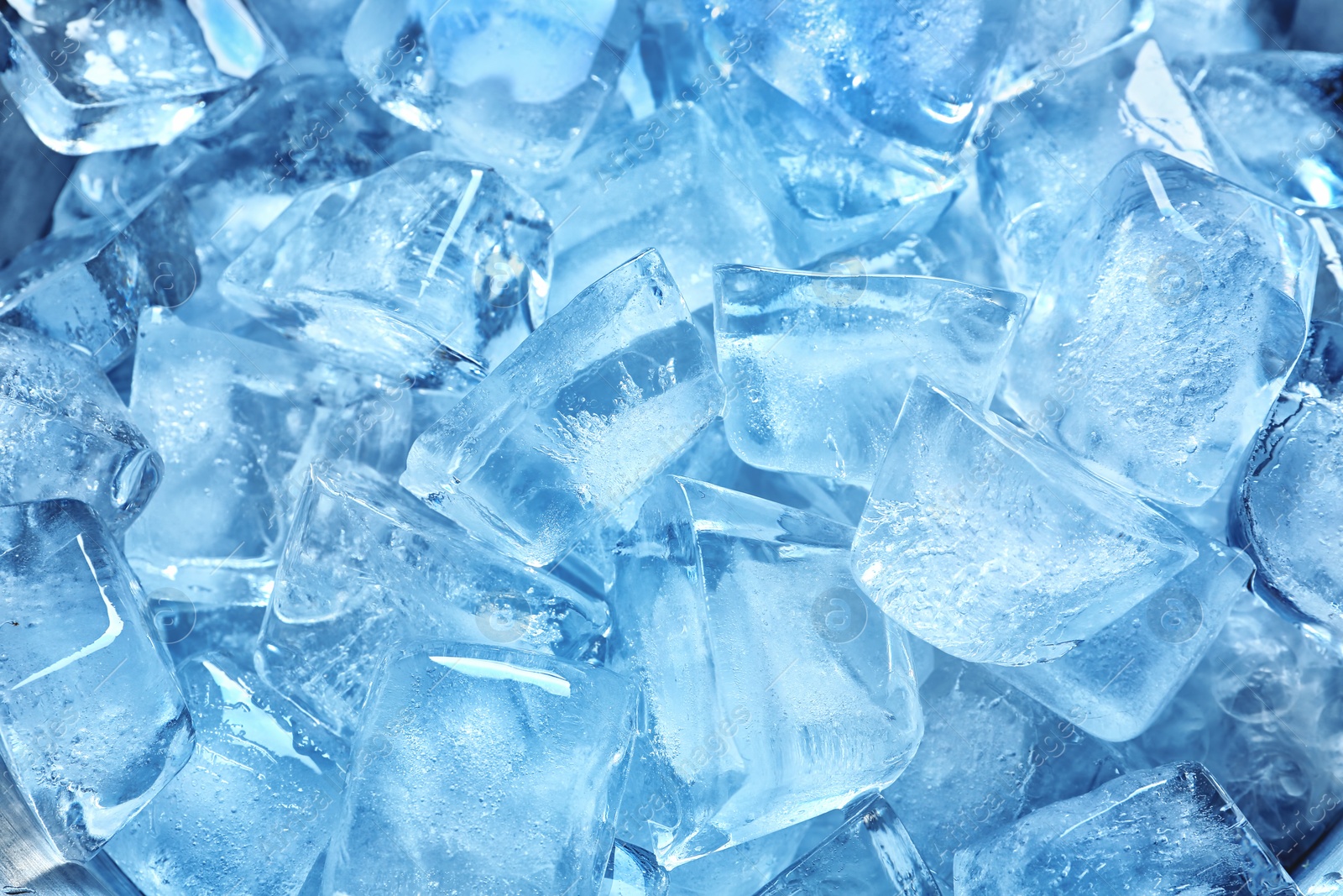 Photo of Many ice cubes on color background, top view