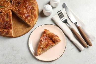 Photo of Tasty homemade pie served on light grey table, flat lay