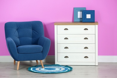 Photo of Stylish room interior with chest of drawers