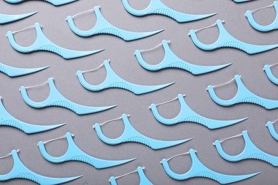 Photo of Flat lay composition with dental floss picks on grey background