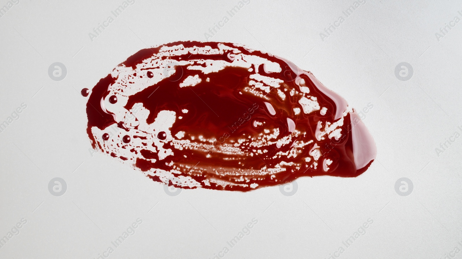 Photo of Stain of blood on grey background, top view