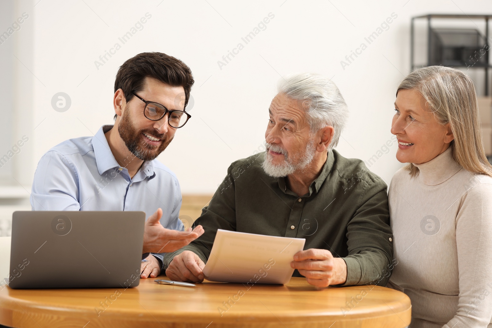 Photo of Notary consulting senior couple about Last Will and Testament in office