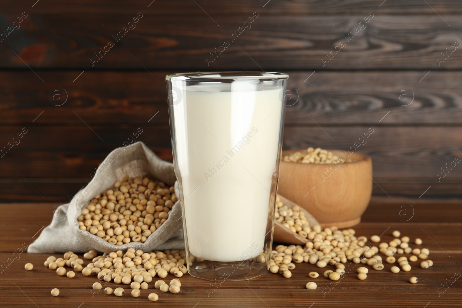 Photo of Fresh soy milk and beans on wooden table