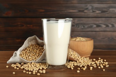 Photo of Fresh soy milk and beans on wooden table