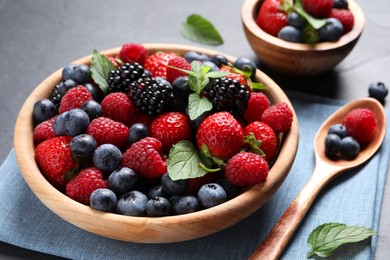 Photo of Many different fresh ripe berries on black table, closeup